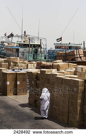 Stock Image - Cargo piled up on the waterfront; Dubai, United Arab Emirates. Fotosearch