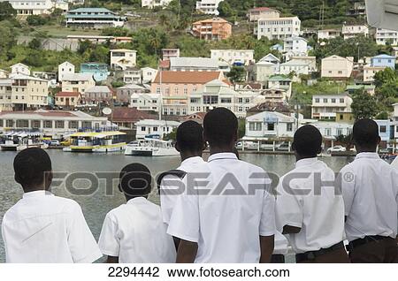 Stock Image - Caribbean, Carriacou and Petite Martinique Ferry; Grenada, Grenada, Local schoolboys admire St George's harbor onboard Osprey Express. Fotosearch
