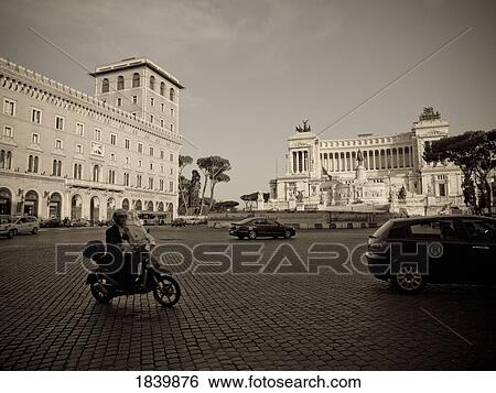 Stock Photograph - Cars And Motorcycle On Town Square; Rome, Italy. Fotosearch