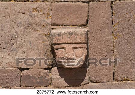 Stock Image - Carved stone tenon-head embedded in the wall of the Semi-subterranean Temple, Tiwanaku, La Paz Department, Bolivia. Fotosearch