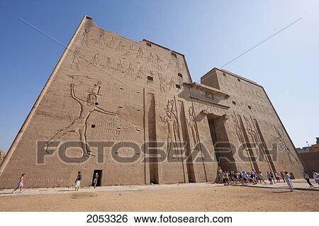Stock Photograph - Carvings On The Massive Twin Towers Of The 36M High Entrance Pylon Of The Temple Of Horus At Edfu, Aswan, Egypt. Fotosearch