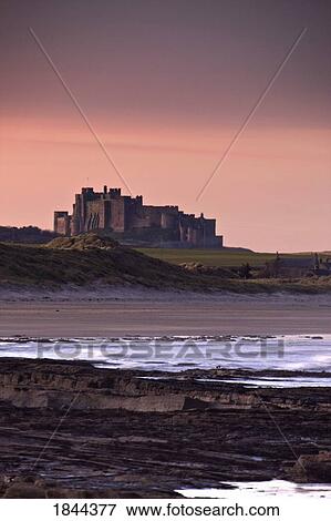 Stock Photo - Castle At Dusk; Northumberland, England, Uk. Fotosearch