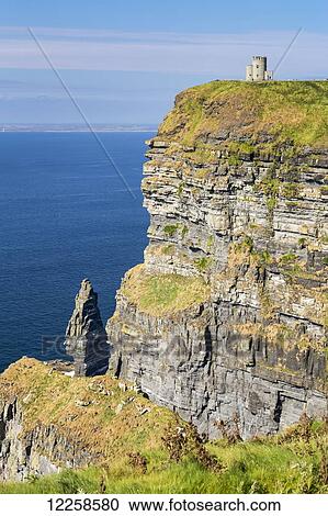 Castle turret on dramatic cliff overlooking the ocean with blue sky; Liscannor, County Clare, Ireland View Large Photo Image Stock Image - Castle turret on dramatic cliff overlooking the ocean with blue sky; Liscannor, County Clare, Ireland. Fotosearch