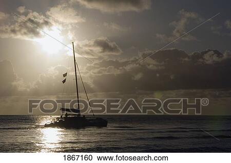 Stock Image - Catamaran On The Pacific At Sunset, North Kauai, Hawaii, Usa. Fotosearch