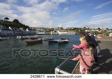 Stock Image - Catching crabs; St. Mawes, Cornwall, England. Fotosearch