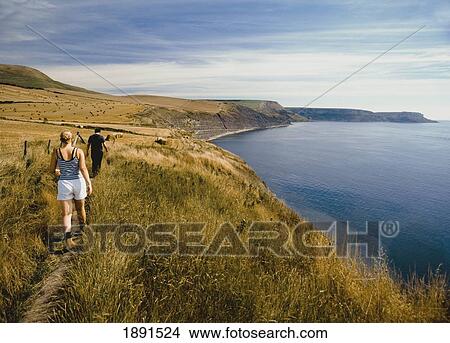 Cauple Walking Along Coastal Path, Rear View View Large Photo Image Picture - Cauple Walking Along Coastal Path, Rear View. Fotosearch