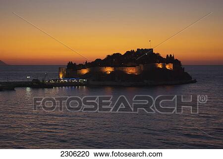Stock Image - Causeway leading to Pigeon Island in restored 14th or 15th century fortress with restaurant and disco; Kusadasi, Izmir, Turkey. Fotosearch