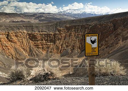 Caution Sign At Edge Of Ubehebe Crater Hiking Trail In Death Valley National Park; California Usa View Large Photo Image Stock Photo - Caution Sign At Edge Of Ubehebe Crater Hiking Trail In Death Valley National Park; California Usa. Fotosearch