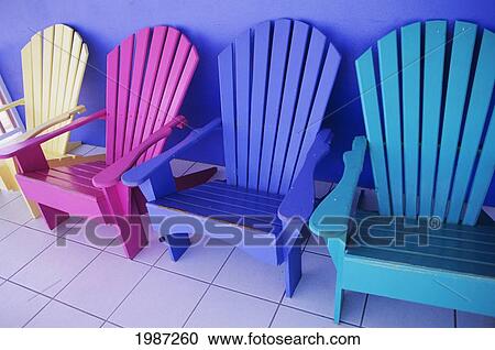 Cayman Islands, Grand Cayman, Colorful Wooden Chairs Against Purple Wall Of Storefront. View Large Photo Image Stock Image - Cayman Islands, Grand Cayman, Colorful Wooden Chairs Against Purple Wall Of Storefront.. Fotosearch