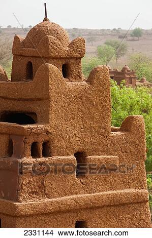 Central Niger, Close up view of one of corner towers of Yaama mud brick mosque. Built 1962-1982 by Master builder El Hadji Falke Barmou using in a creative manner traditional mud brick techniques from Tahoa Region; Yaama Village View Large Photo Image Picture - Central Niger, Close up view of one of corner towers of Yaama mud brick mosque. Built 1962-1982 by Master builder El Hadji Falke Barmou using in a creative manner traditional mud brick techniques from Tahoa Region; Yaama Village. Fotosearch