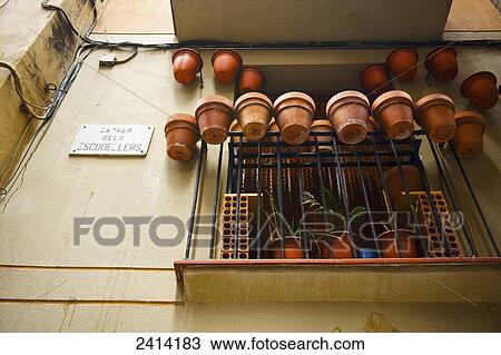Ceramic flower pots hanging on the edge of a metal railing on a residential balcony; Barcelona, Spain View Large Photo Image Stock Image - Ceramic flower pots hanging on the edge of a metal railing on a residential balcony; Barcelona, Spain. Fotosearch