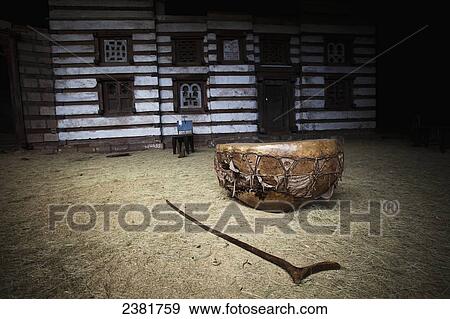 Stock Photo - Ceremomial drum and staff outside the Yemrehanna Kristos Church, near Lalibela; Ethiopia. Fotosearch