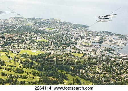 Picture - Cessna Caravan Amphibian Seaplane On Approach To Waterfront At Victoria Harbour; Victoria Vancouver Island British Columbia Canada. Fotosearch