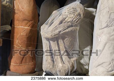 Stock Photograph - Chachapoya mummy bundles recovered from the cliff tombs of Laguna de los display at the Leymebamba Museum, Leymebamba, Amazonas, Peru. Fotosearch