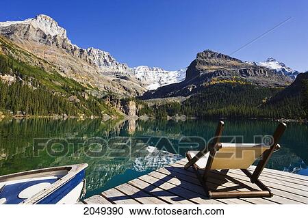 Stock Image - Chair On A Dock, Lake O'hara And Mountains, Yoho National Park, British Columbia. Fotosearch