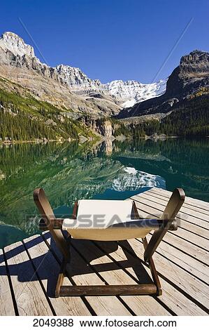 Stock Photo - Chair On A Dock, Lake O'hara And Mountains, Yoho National Park, British Columbia. Fotosearch