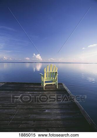 Stock Photography - Chair On End Of Pier At Dawn. Fotosearch