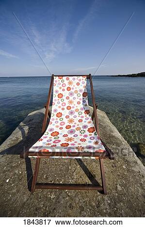 Stock Photo - Chair On Pier; Northumberland, England, Uk. Fotosearch