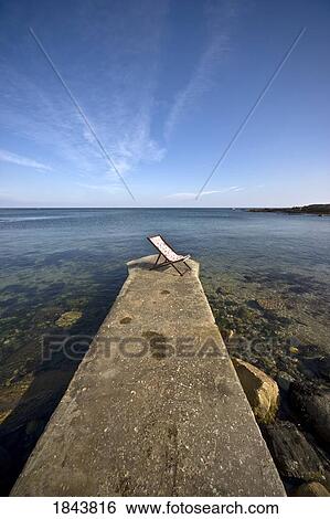 Chair On Pier; Northumberland, England, Uk View Large Photo Image Stock Photograph - Chair On Pier; Northumberland, England, Uk. Fotosearch