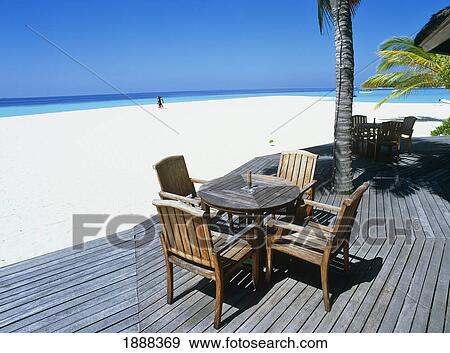 Chairs And Table On Deck By Beach View Large Photo Image Stock Photo - Chairs And Table On Deck By Beach. Fotosearch