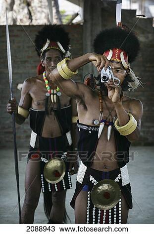 Stock Image - Chang Naga Tribal Warriors Taking A Picture With A Camera; Nagaland India. Fotosearch