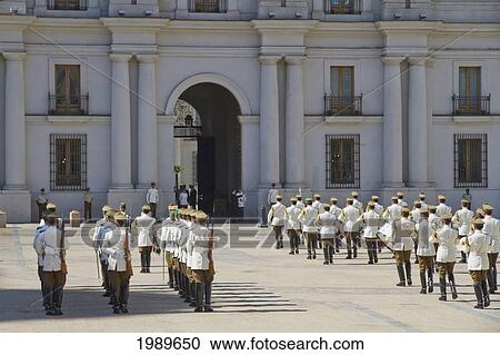 Stock Image - Changing of the guards by Carabineros on Plaza de la Constitucion in front of the Palacio de la Moneda Presidential Palace, Santiago, Metropolitan Region, Chile. Fotosearch