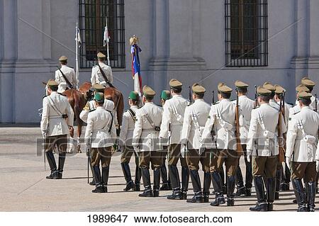 Changing of the guards by Carabineros on Plaza de la Constitucion in front of the Palacio de la Moneda Presidential Palace, Santiago, Metropolitan Region, Chile View Large Photo Image Stock Photo - Changing of the guards by Carabineros on Plaza de la Constitucion in front of the Palacio de la Moneda Presidential Palace, Santiago, Metropolitan Region, Chile. Fotosearch