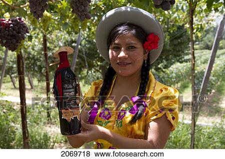 Chapaca Holding A Bottle Of Red Wine In A Vineyard Of Calamuchita, Tarija, Bolivia View Large Photo Image Stock Photo - Chapaca Holding A Bottle Of Red Wine In A Vineyard Of Calamuchita, Tarija, Bolivia. Fotosearch