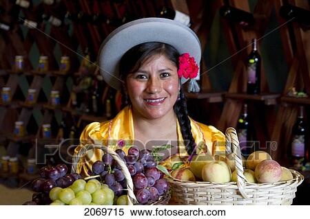 Stock Photography - Chapaca In Front Of Fruit Baskets At The Las Duelas Wine And Specialties Store, Uriondo, Tarija, Bolivia. Fotosearch
