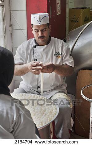 Picture - Chefs Preparing Traditional Arabic Sweets, Mediterranean Sweets Or Middle Eastern Sweets Made At The Zalatimo Sweetshop, Amman, Jordan, Middle East. Fotosearch