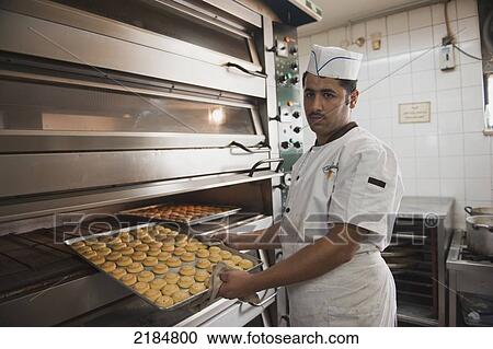 Stock Image - Chefs Preparing Traditional Arabic Sweets, Mediterranean Sweets Or Middle Eastern Sweets Made At The Zalatimo Sweetshop, Amman, Jordan, Middle East. Fotosearch