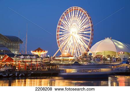 Stock Photo - Chicago, Illinois Boat Pull Away From Dock At Navy Pier At Night, Ferris Wheel And Skyline Stage. Fotosearch