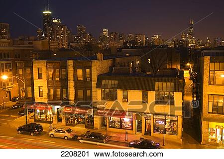 Stock Image - Chicago, Illinois Stores, Businesses And Restaurants Along North Avenue At Night, City Skyline Viewed From Old Town Neighborhood. Fotosearch