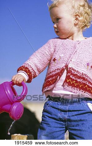 Child Holding Watering Can View Large Photo Image Stock Photo - Child Holding Watering Can. Fotosearch