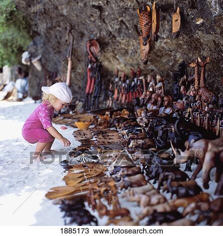 Child Looking At Wooden Souvenirs For Sale On The Beach View Large Photo Image Stock Image - Child Looking At Wooden Souvenirs For Sale On The Beach. Fotosearch