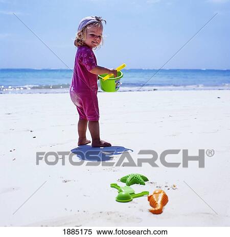 Child Playing On Beach With Bucket And Spade View Large Photo Image Stock Photography - Child Playing On Beach With Bucket And Spade. Fotosearch