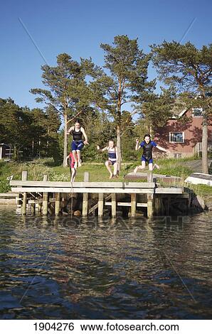 Children (8-15) Jumping Off Pier Into Sea, Foglo, Aland Islands, Finland View Large Photo Image Stock Photograph - Children (8-15) Jumping Off Pier Into Sea, Foglo, Aland Islands, Finland. Fotosearch
