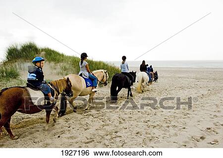 Stock Photograph - Children At Riding Horses At The Ridecenter Vinterlejegaard Situated In A Dune Landscape On The Isthmus Holmsland Klit, West Jutland Denmark. Fotosearch