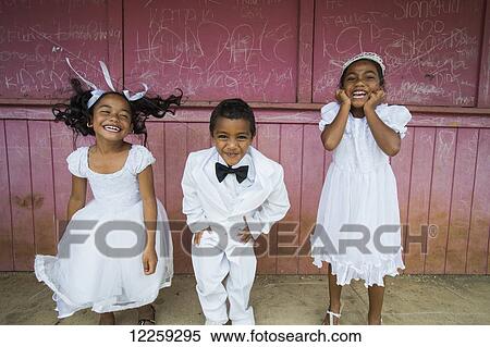 Children dressed in white formal wear against a red wall; Hapai Island, Tonga View Large Photo Image Stock Photography - Children dressed in white formal wear against a red wall; Hapai Island, Tonga. Fotosearch
