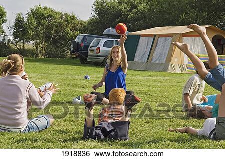 Stock Photograph - Children Having Fun On A Camping Holiday, Pevensey Bay, East Sussex, England, United Kingdom. Fotosearch