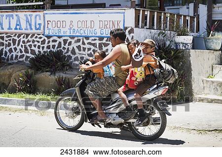 Picture - Children on a motorcycle, Simanindo, Samosir Island, Lake Toba, North Sumatra, Indonesia. Fotosearch