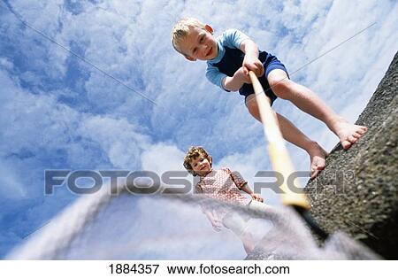 Stock Photo - Children Playing In Rock Pool. Fotosearch