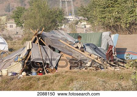 Stock Image - Children Playing On A Tent In A Relief Camp After The 8 October 2005 Earthquake, Bagh, Azad Kashmir, Pakistan. Fotosearch
