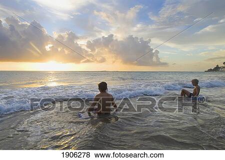Stock Photo - Children Playing On Beach At Dusk, Treasure Beach, Jamaica. Fotosearch