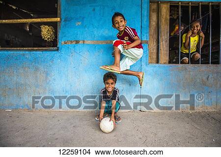 Picture - Children playing outside a local store; Timor-Leste. Fotosearch