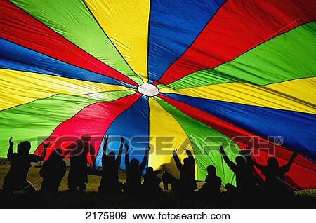 Children Playing With A Rainbow-Coloured Parachute; Edmonton Alberta Canada View Large Photo Image Stock Photo - Children Playing With A Rainbow-Coloured Parachute; Edmonton Alberta Canada. Fotosearch