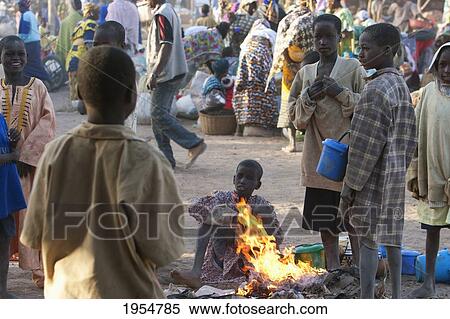 Children warm up by a fire at the Monday Market, Djenne, Mali View Large Photo Image Stock Photography - Children warm up by a fire at the Monday Market, Djenne, Mali. Fotosearch