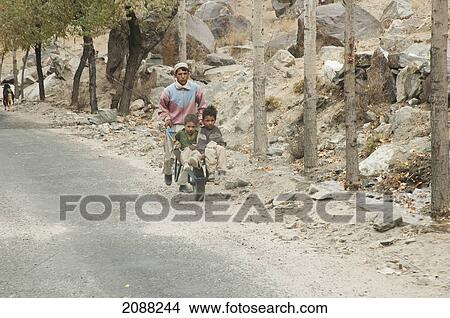 Children With A Wheelbarrow, Dambudas, Northern Areas, Pakistan View Large Photo Image Picture - Children With A Wheelbarrow, Dambudas, Northern Areas, Pakistan. Fotosearch