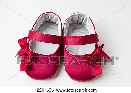 Stock Photography - Child's red shoes with bows; Chilliwack, British Columbia, Canada. Fotosearch