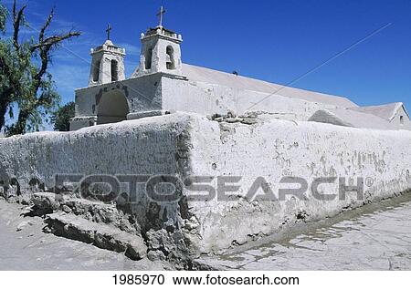 Stock Image - Chile, San Pedro De Atacama, Detail of crumbled white wall and building against blue sky; San Pedro Church. Fotosearch